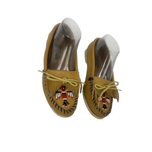 Minnetonka tan leather moccasins with beaded thunderbird design